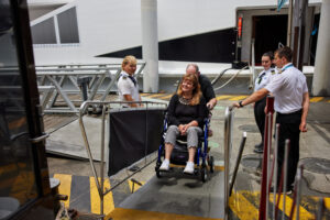 Woman in wheelchair with companion on the boat ramp 300x200